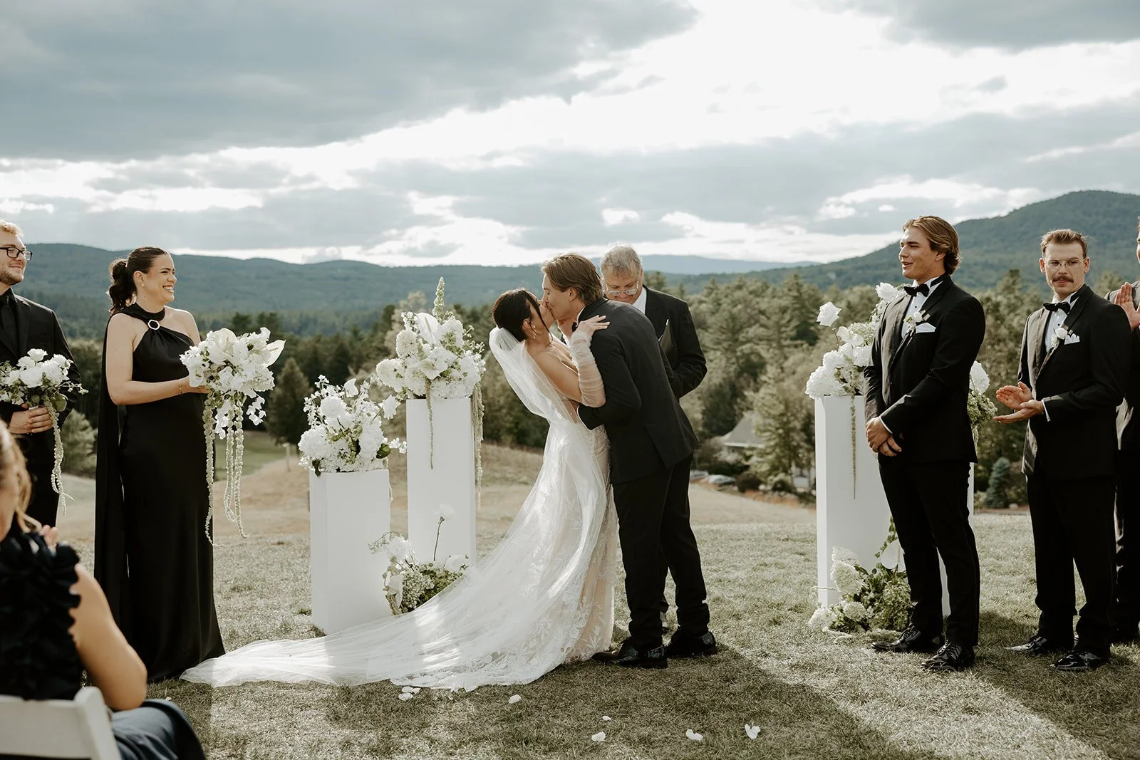 A bride and groom's first kiss after their wedding planning checklist is complete