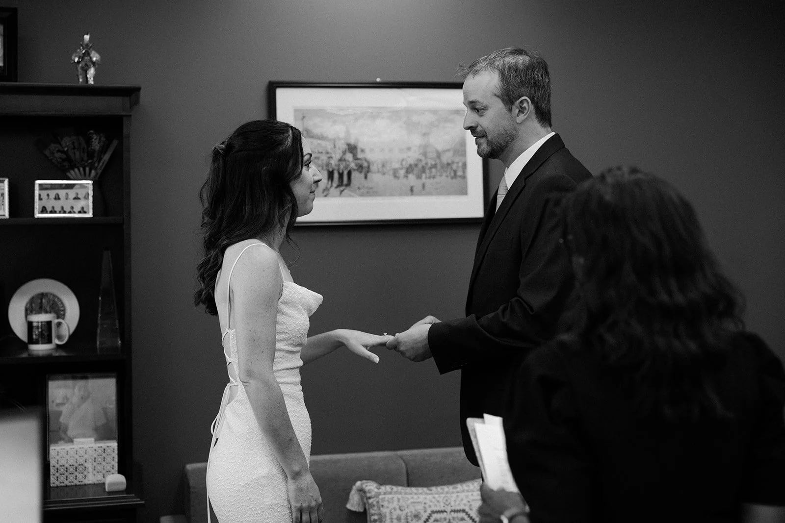 a bride and groom exchanging rings at a boston city hall wedding