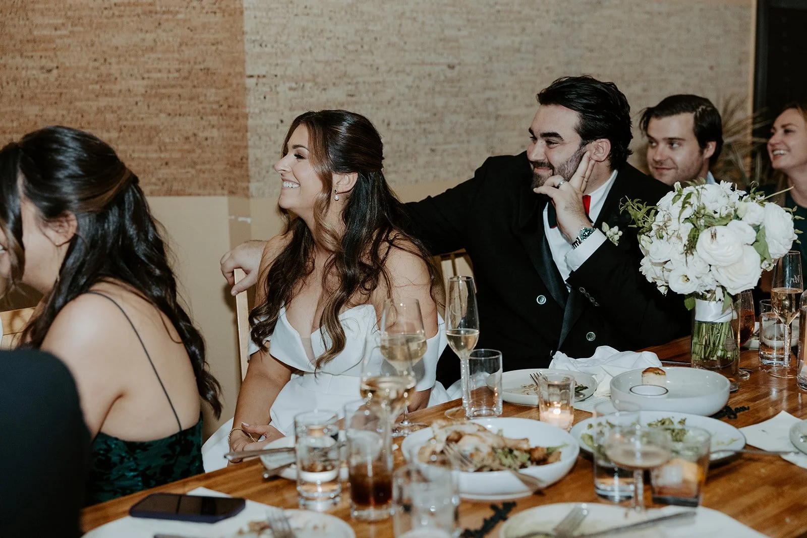 A bride and groom in a candid photo at their wedding reception