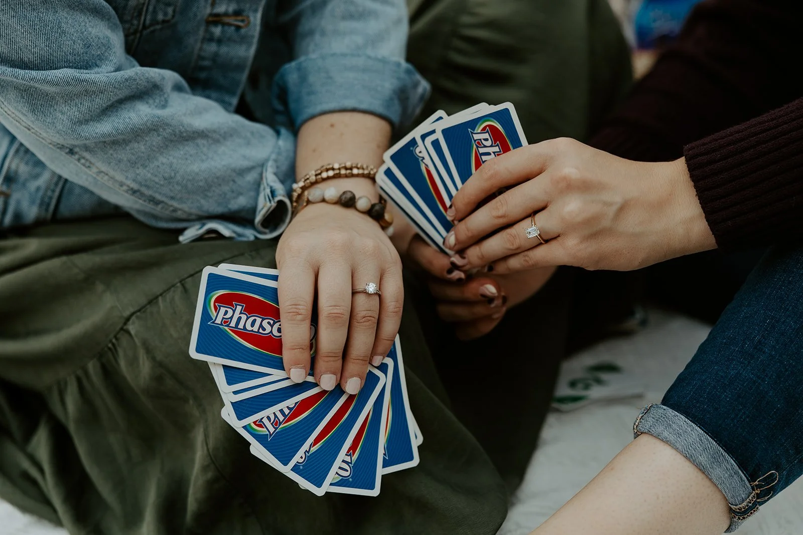 A couple holding cards during an engagement photsohoot