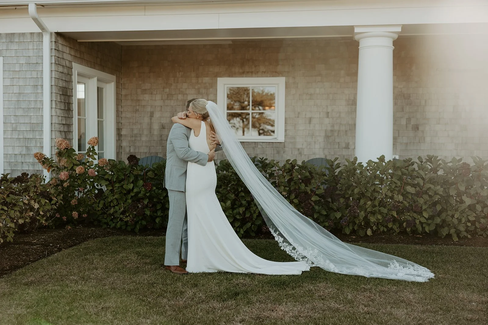 A bride and groom hugging during a wedding first look