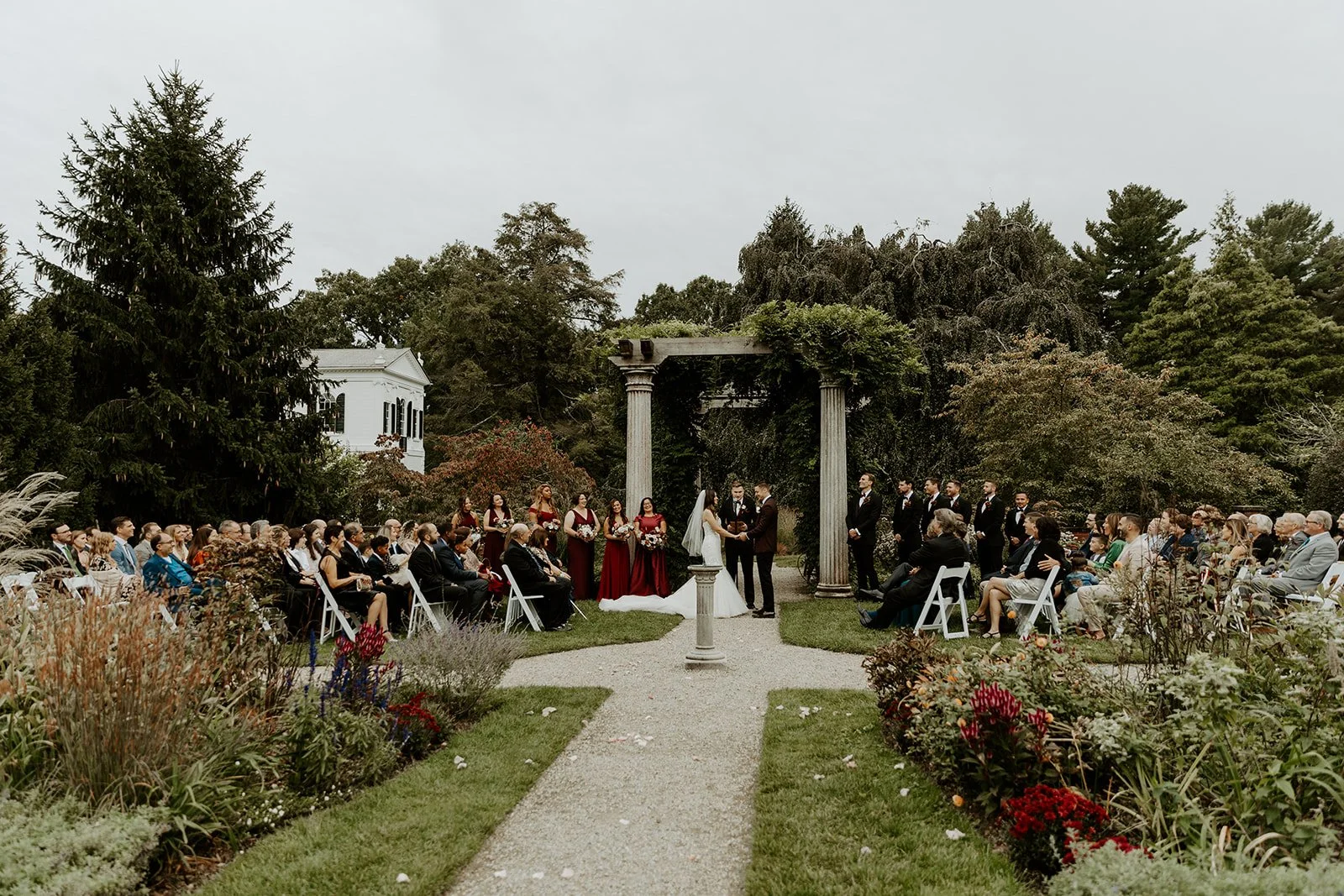 A fall wedding ceremony taking place at Glen Magna Farms