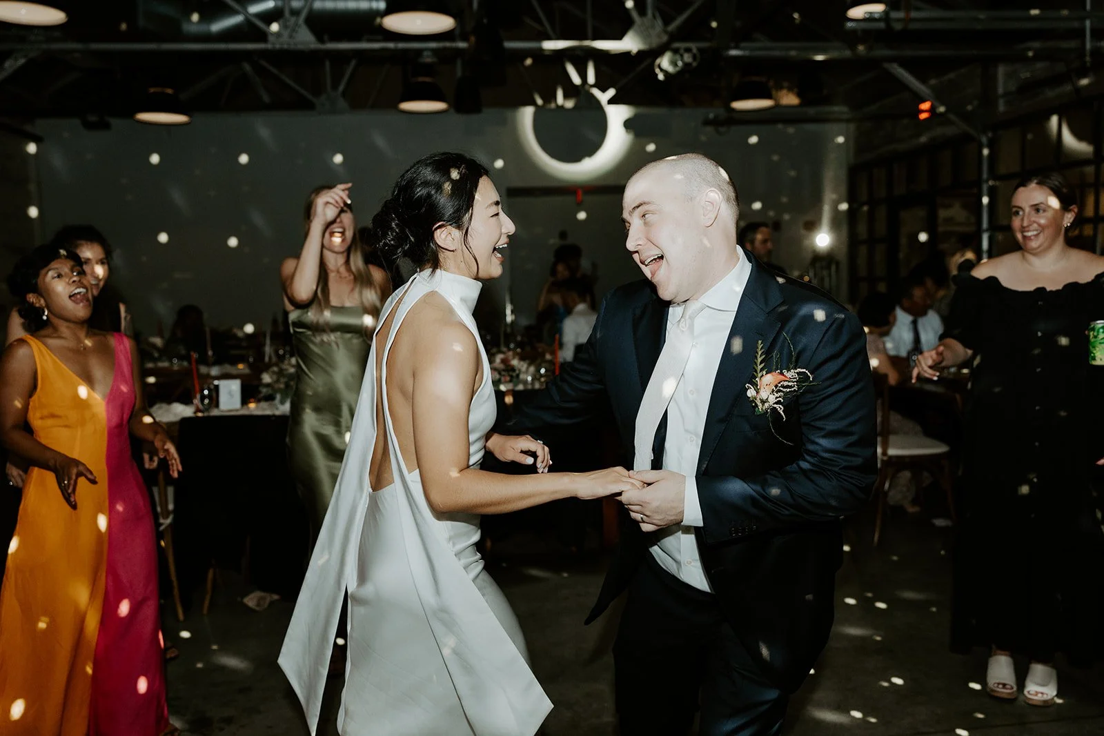 A bride and groom dancing at a wedding reception