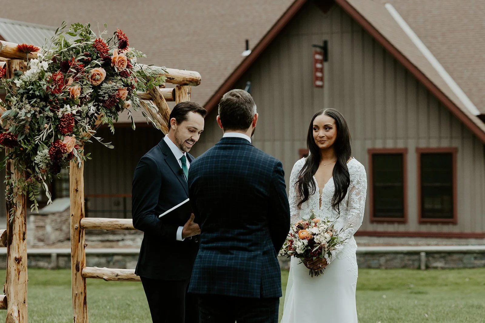 A bride and groom during their wedding ceremony at Sugarbush Inn