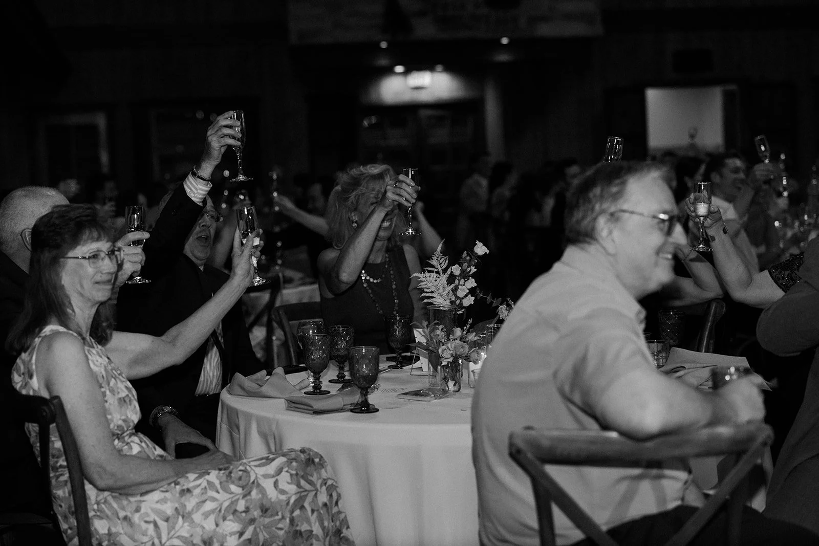 Wedding guests raising their glasses for a toast