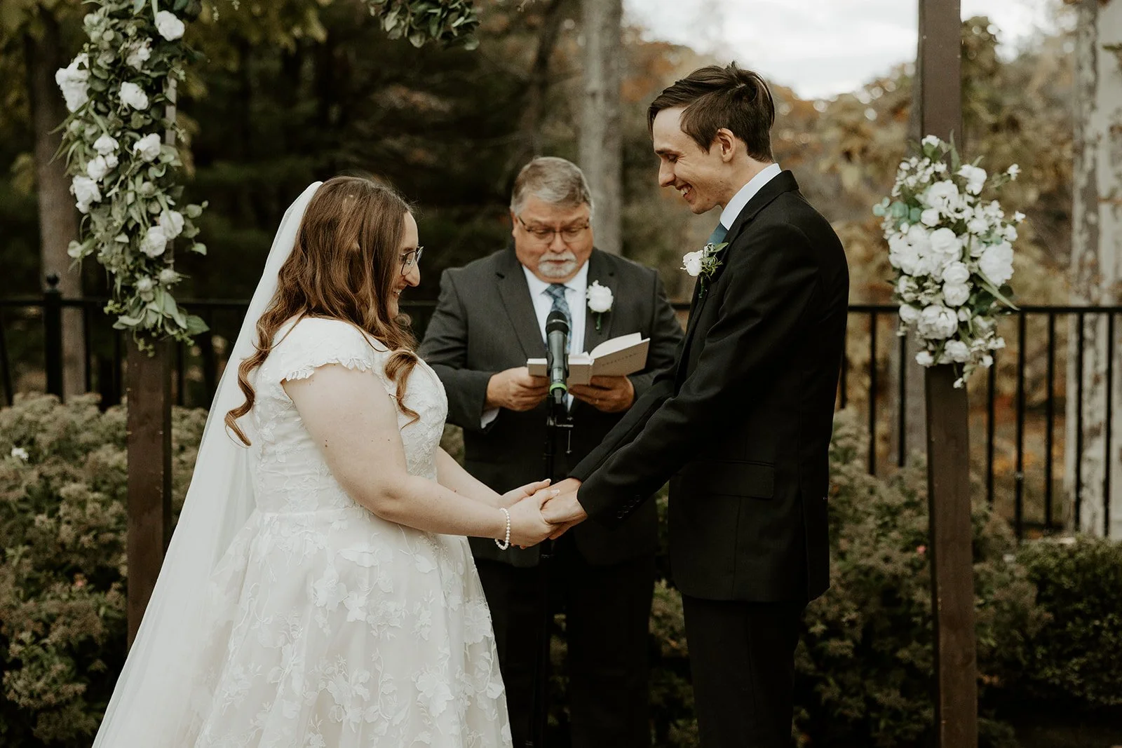 A bride and groom during a wedding ceremony at the Grove at Briar Barn Inn