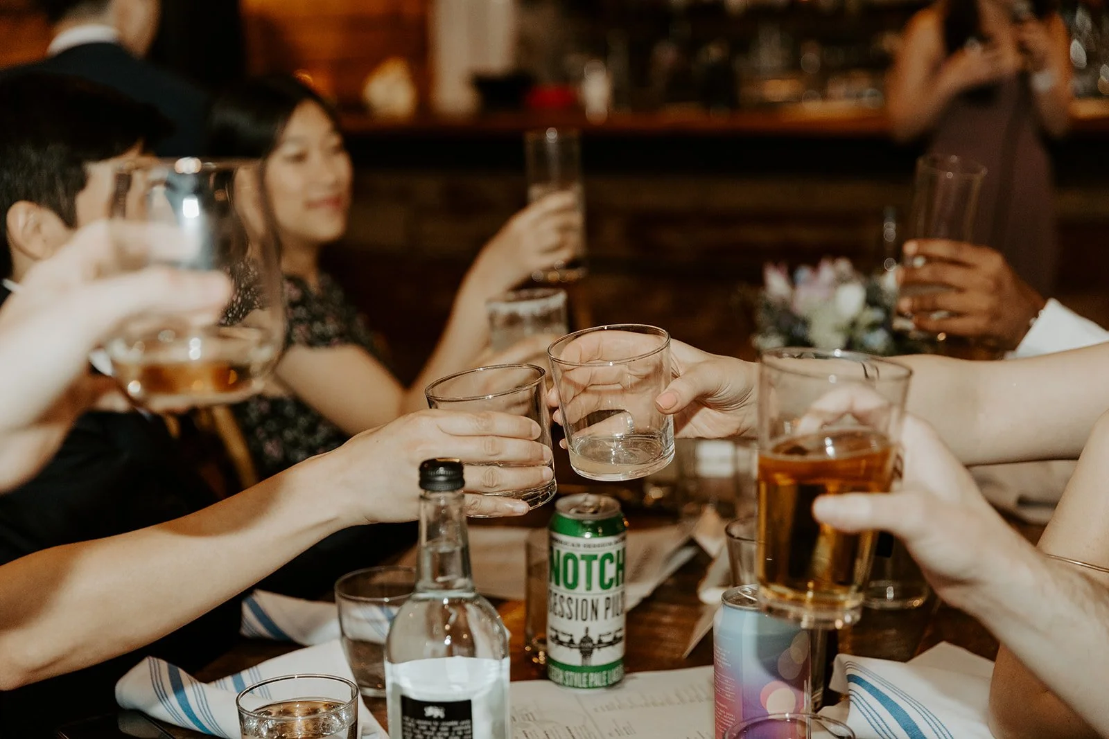 Guests clinking drinks at a wedding reception