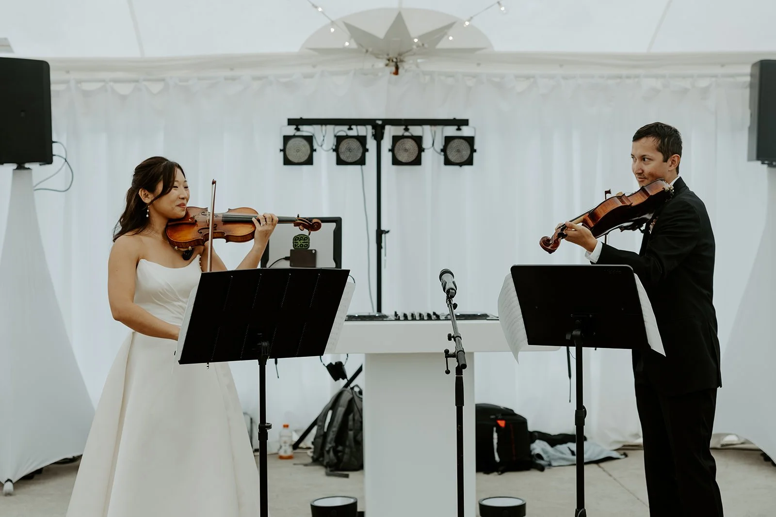 A bride and groom playing instruments instead of doing a first dance at their wedding
