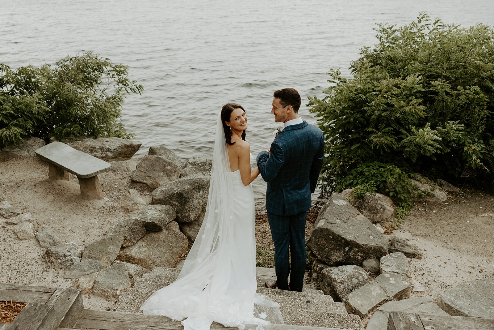 A bride and groom at their waterfront wedding venue