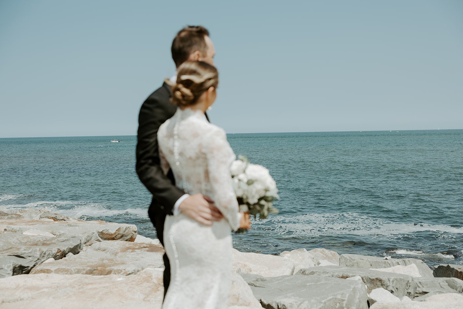A couple at a waterfront wedding venue, demonstrating how to plan a wedding in summer