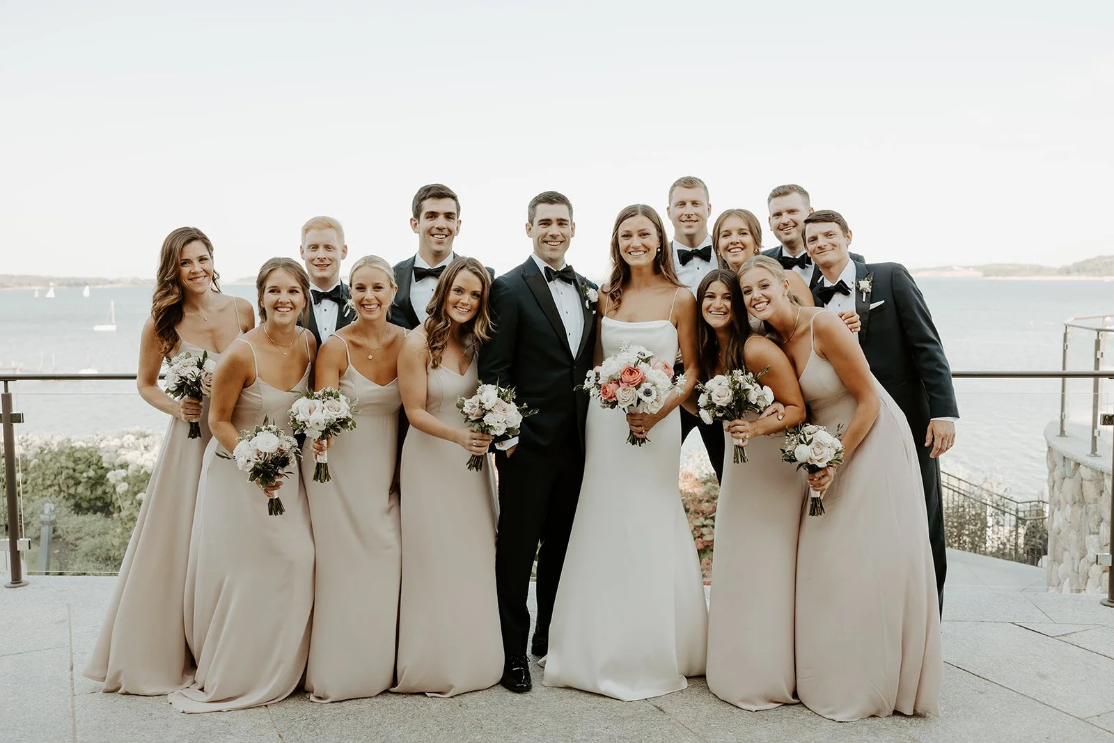 A wedding party posing for wedding photos at a cape cod wedding venue