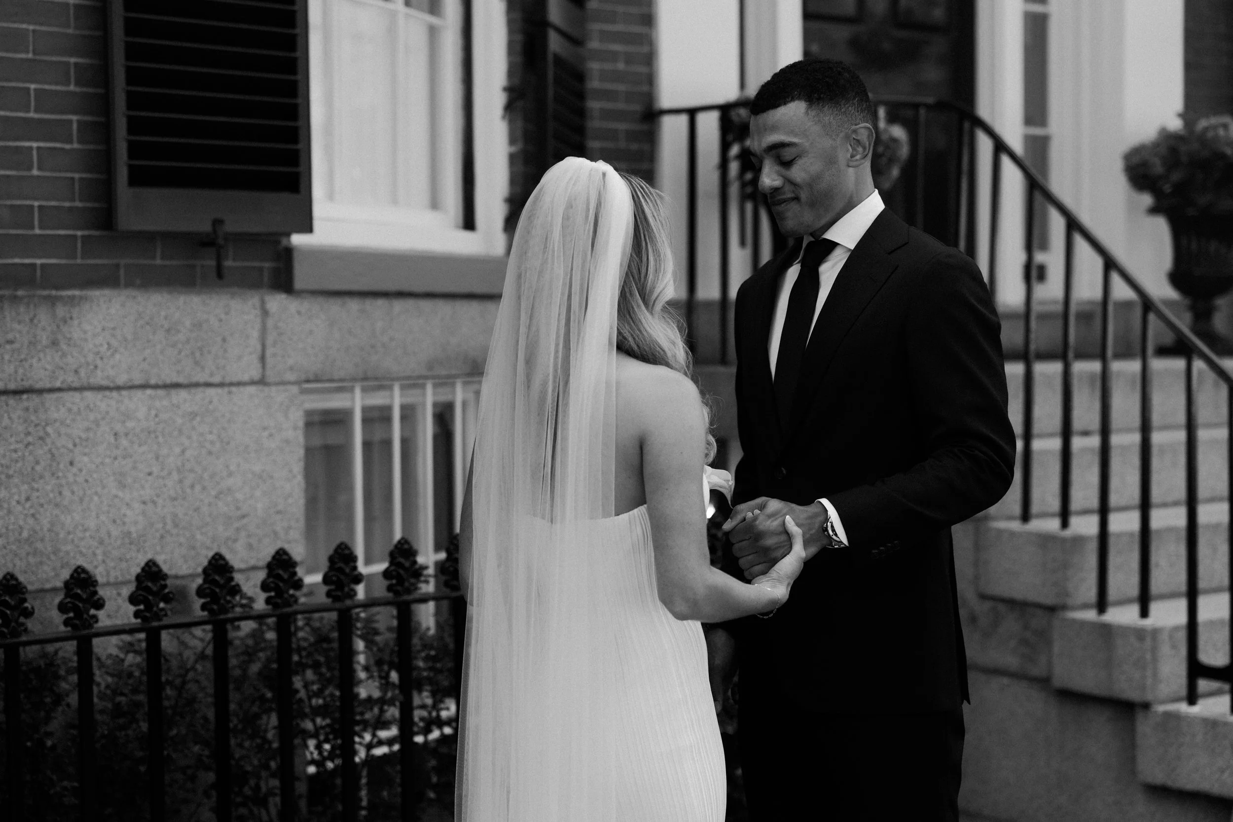 A black and white photo of a couple on the street before heading to their Boston elopement location