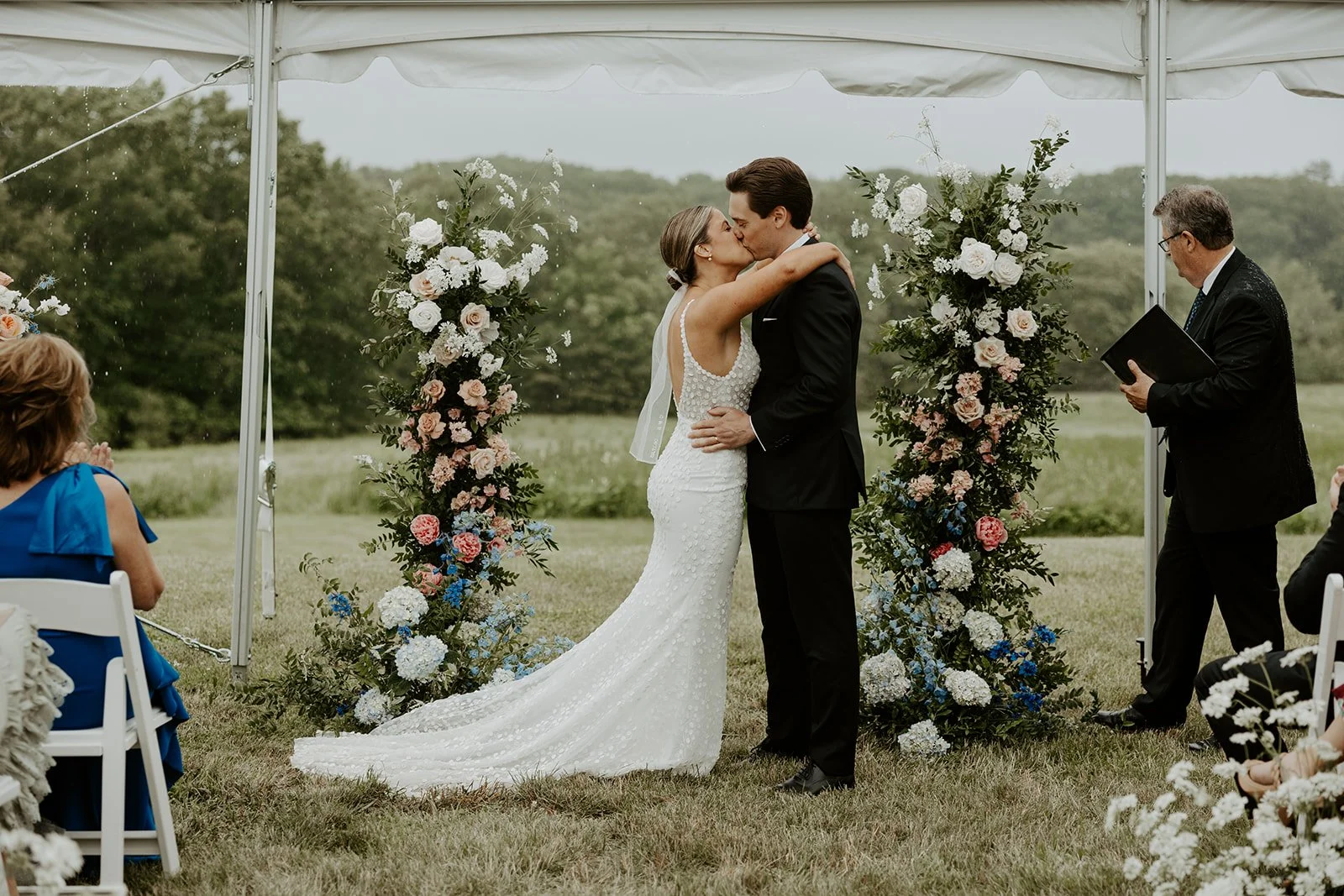 A bride and groom kissing during their wedding ceremony