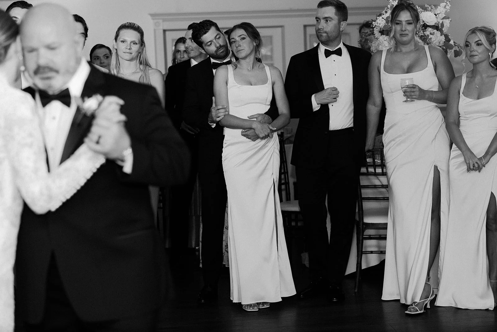 A bride dancing with her father at her Boston wedding while guests watch