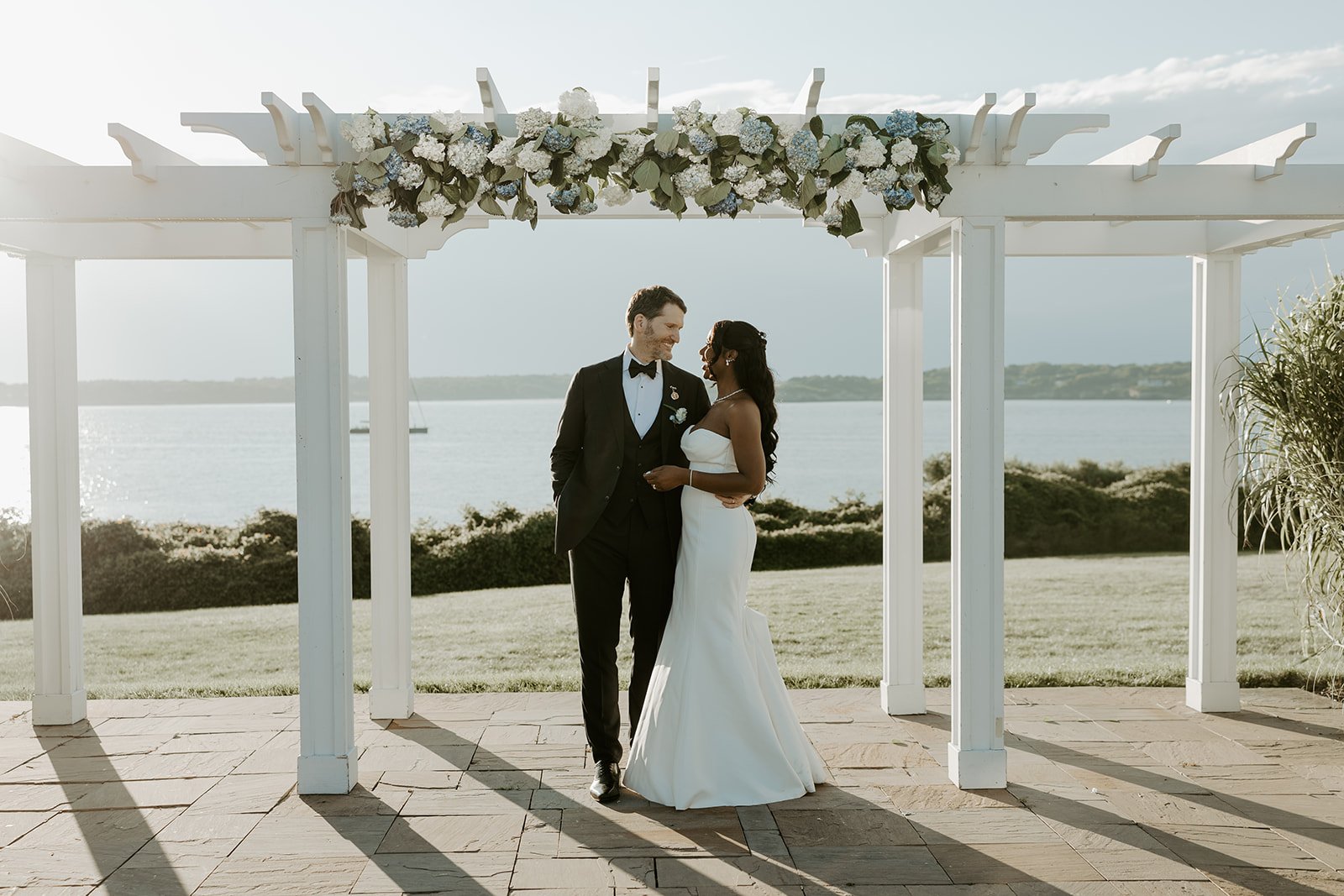 A bride and groom posing for summer wedding photos
