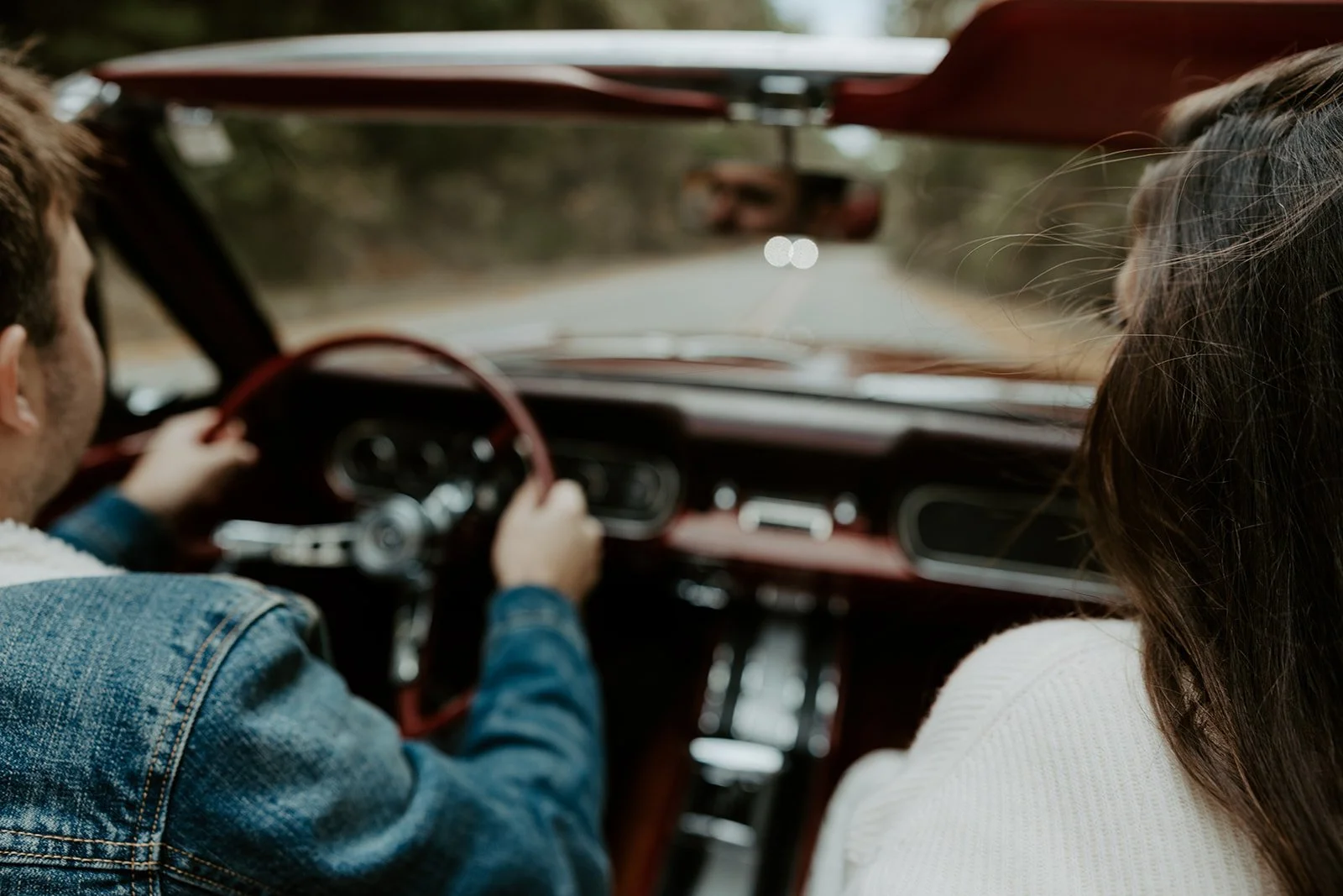A couple driving a car during date night engagement photos