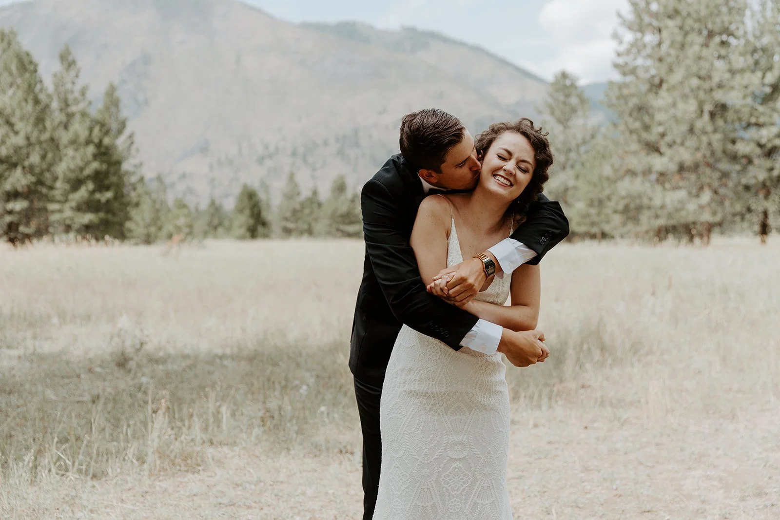 A couple posing in front of the mountains in Montana, showing off destination wedding locations