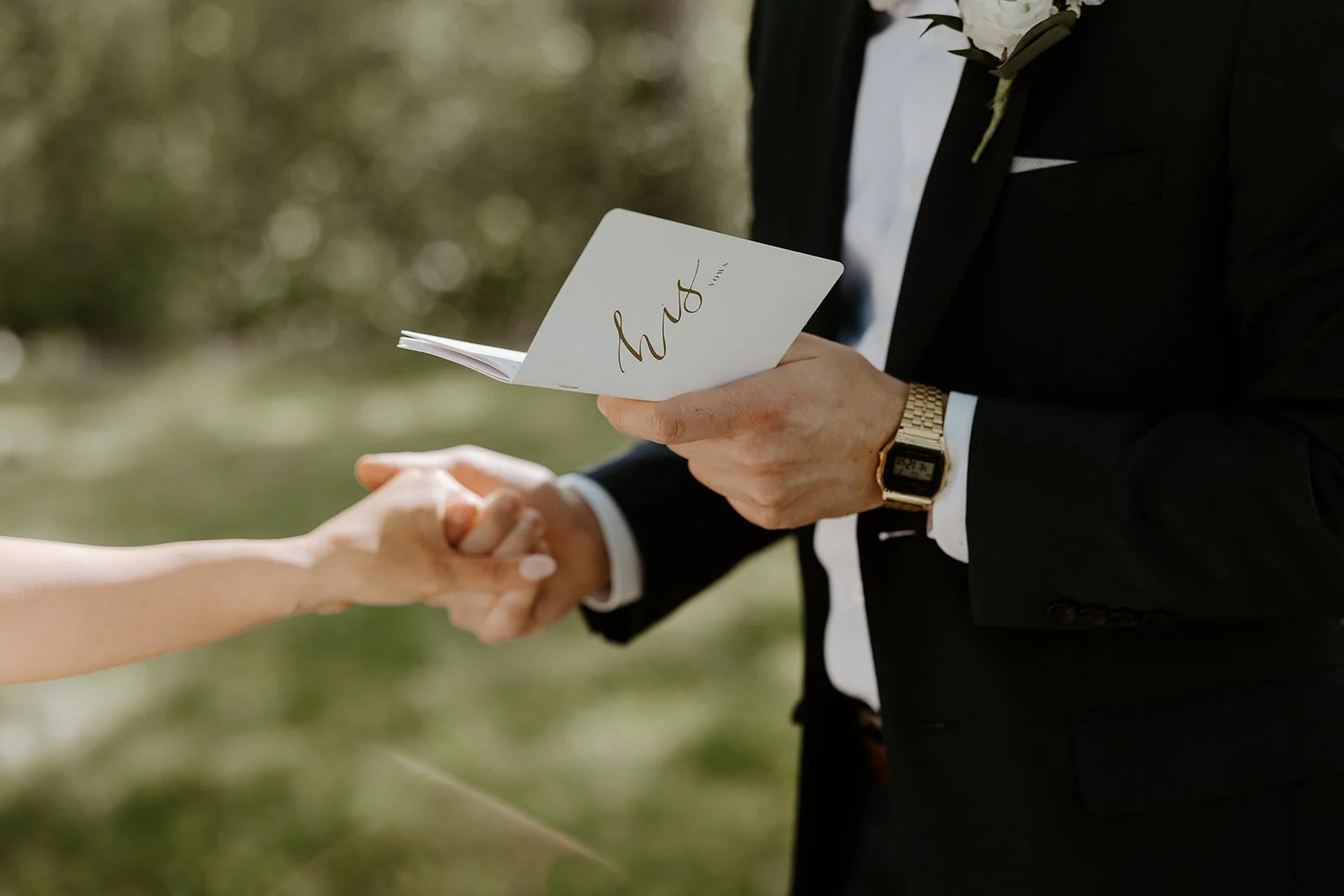A bride and groom reading their private vows to each other