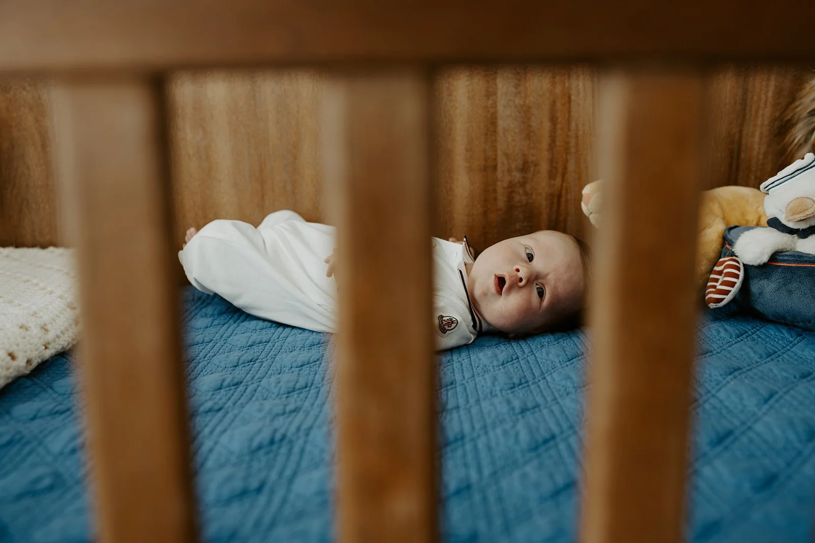 A newborn baby in their crib
