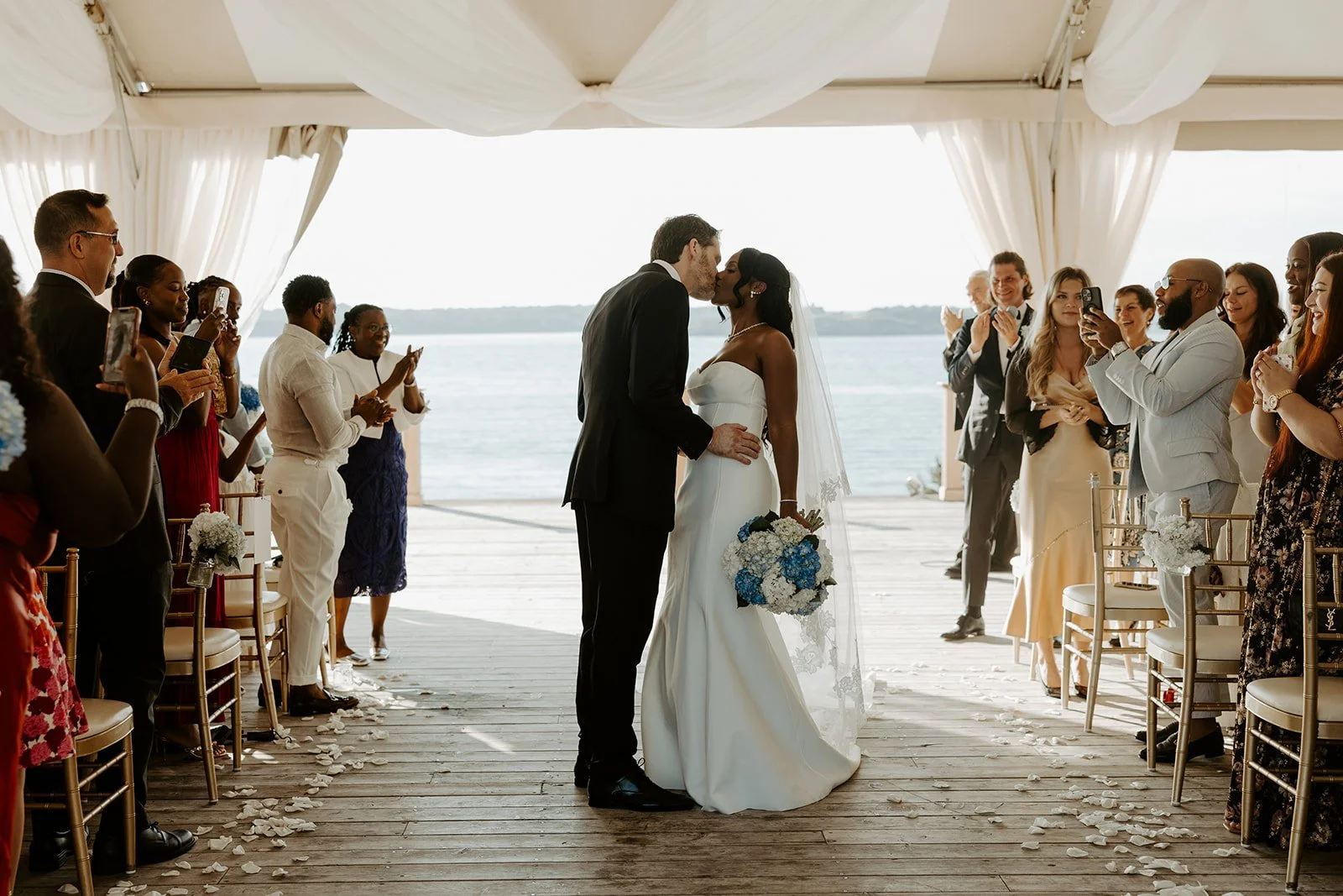a bride and groom kissing at their wedding ceremony