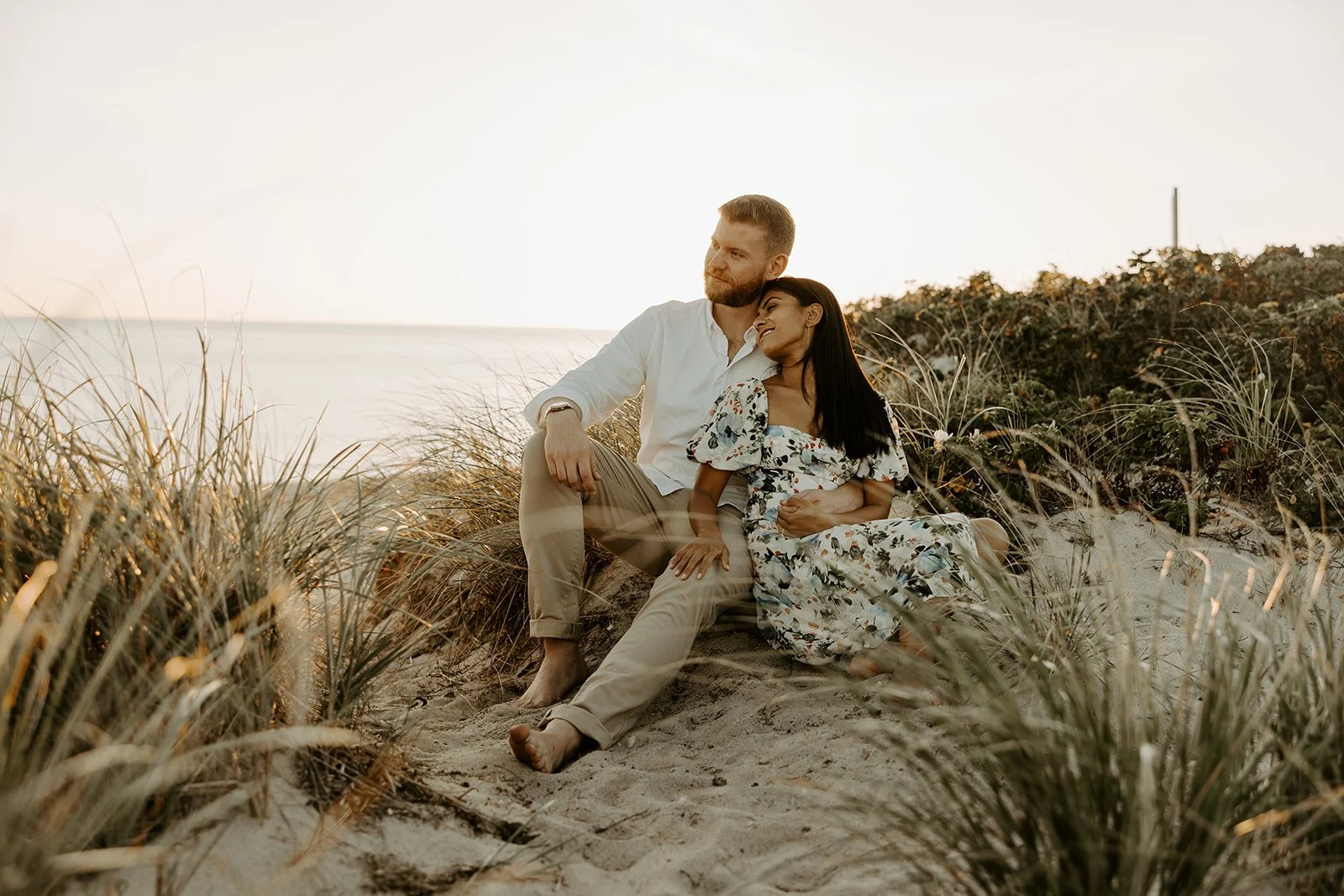 A couple showing what to wear for engagement photos on the beach
