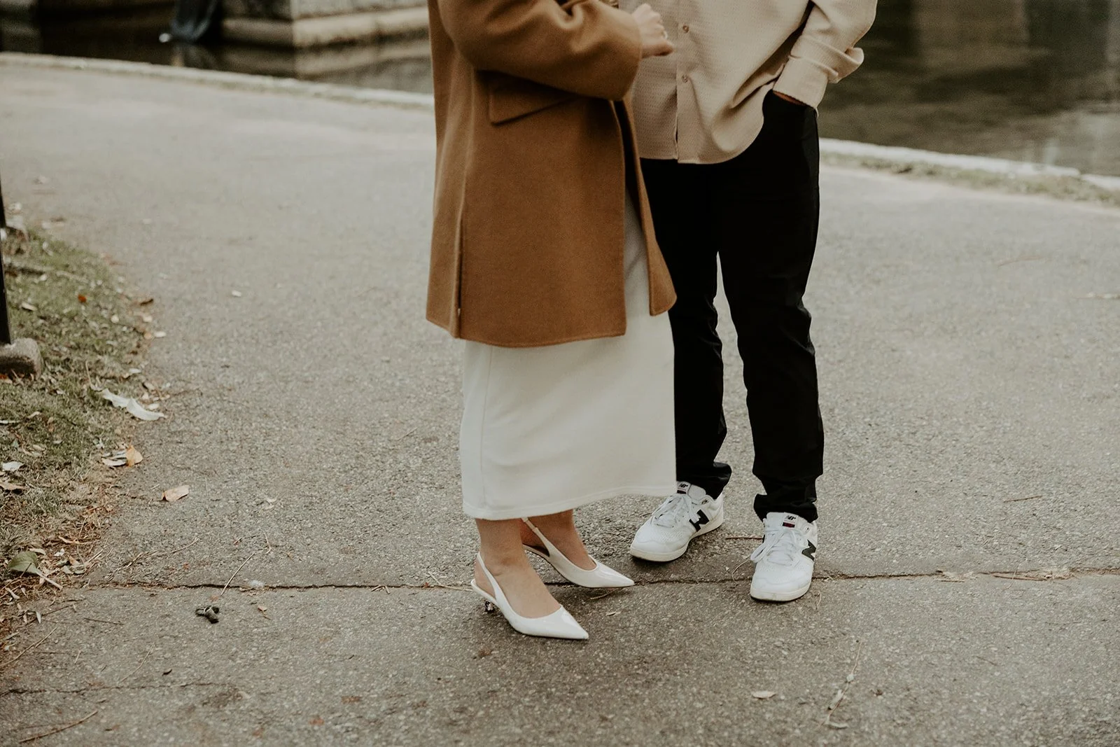 A couple wearing neutral engagement photo outfits