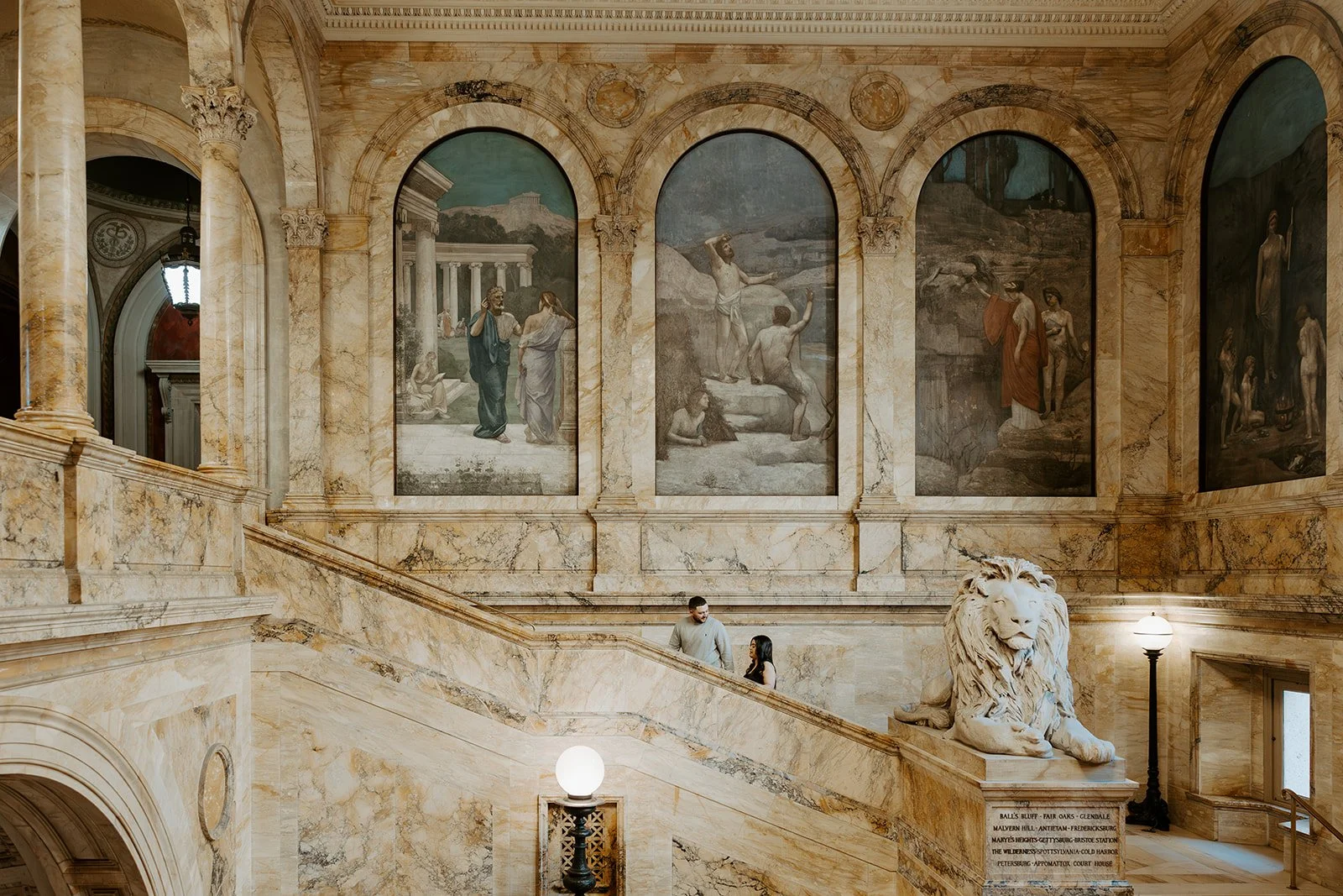 A couple taking art museum engagement photos