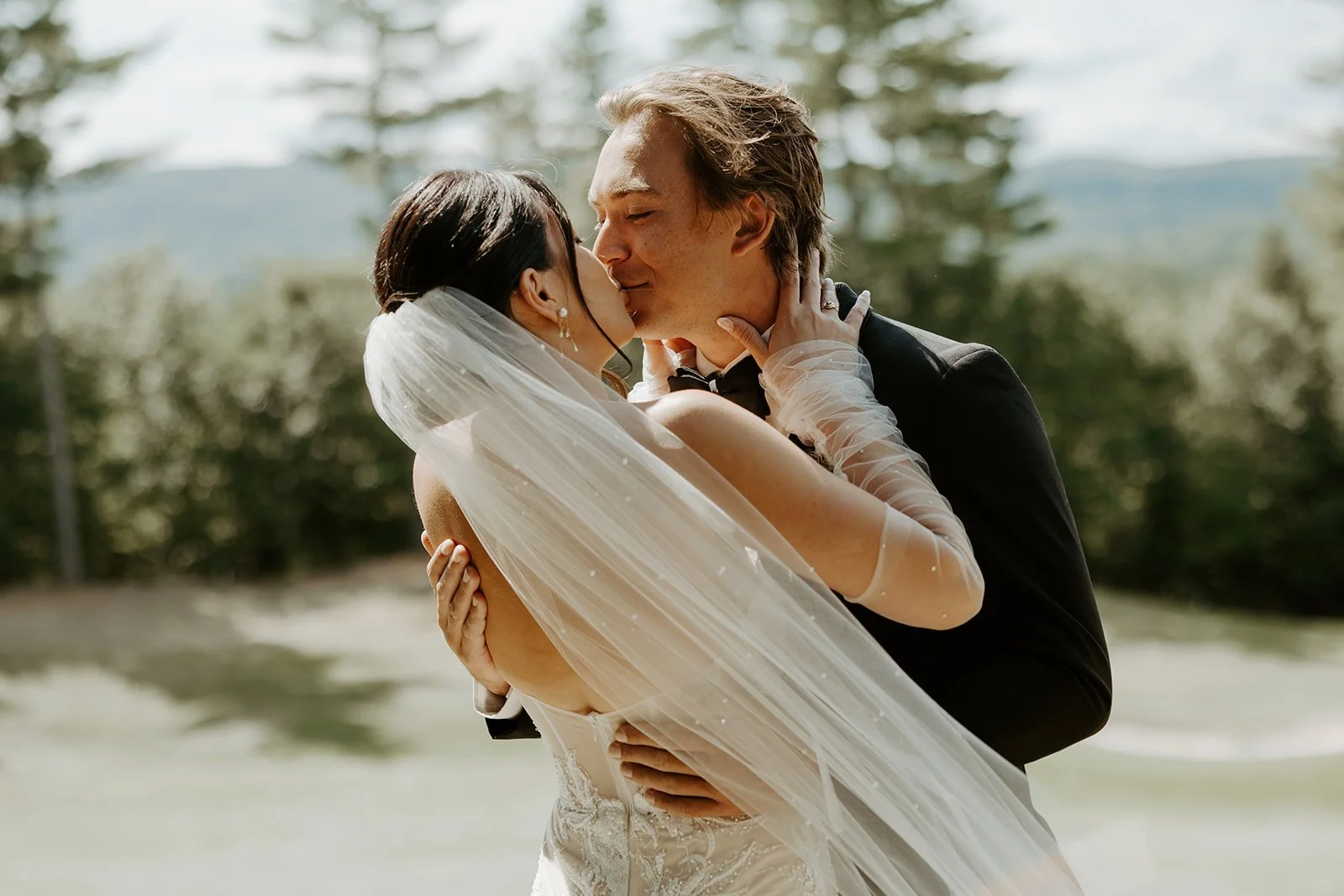 A bride and groom kissing in wedding photos
