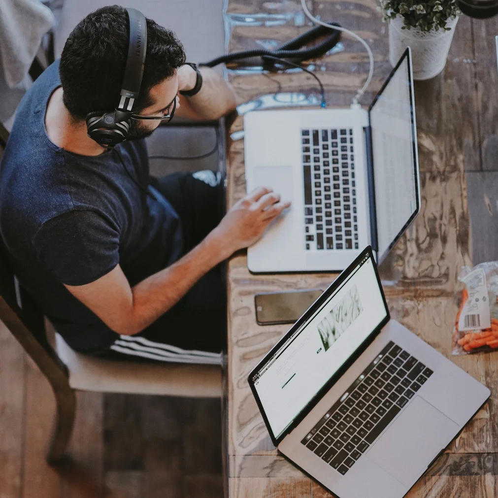 Male Custom Software Developer with Two Laptops
