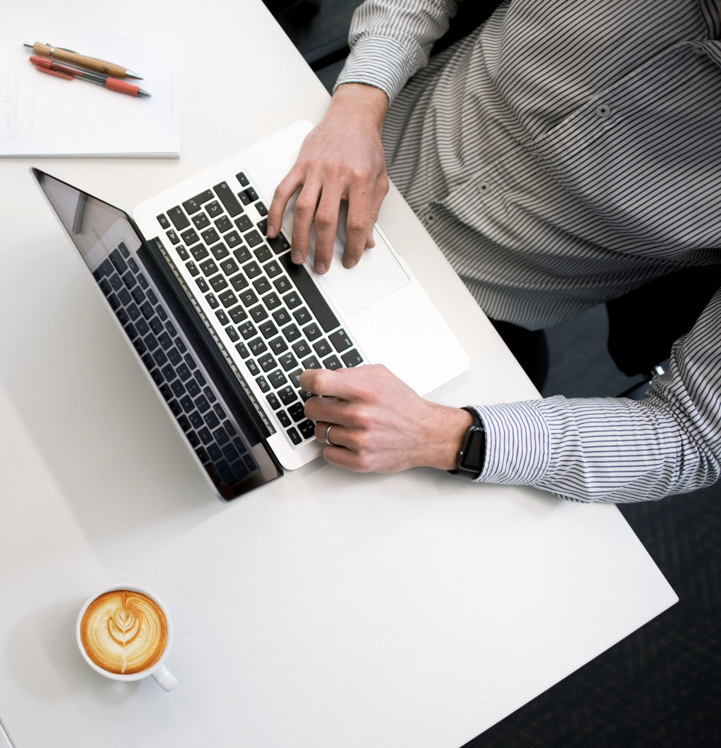 Hands of Male Custom Software Developer on Macbook