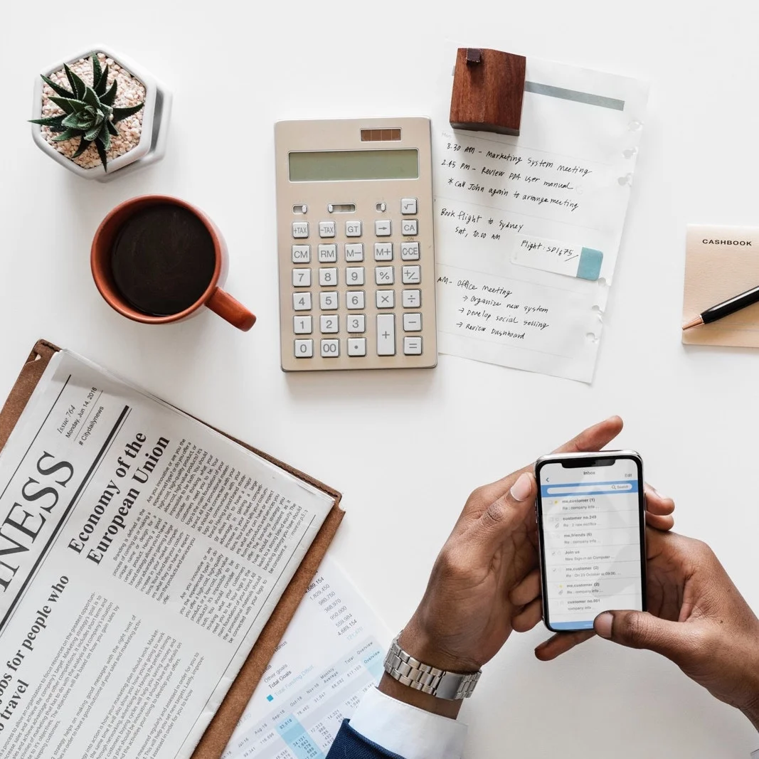 Businessmans Hands Holding Smartphone with Other Desk Supplies