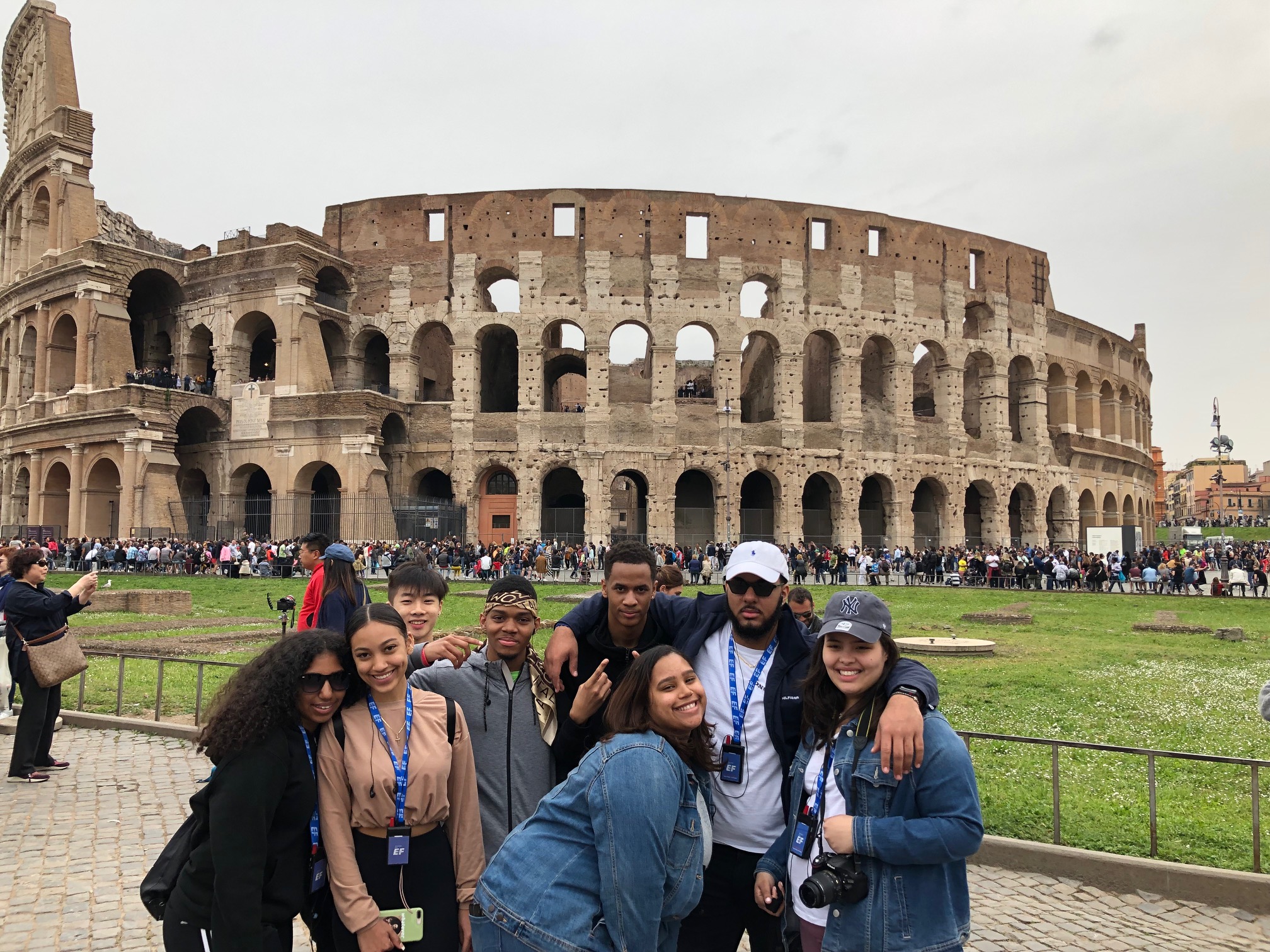 group of students poses in front of Coliseum in Rome
