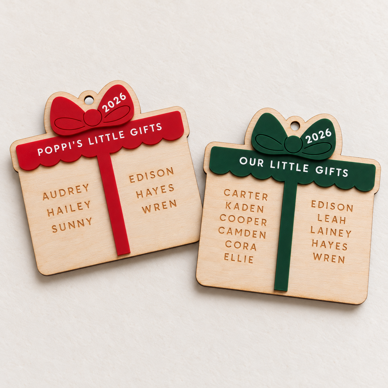 Little Gifts personalized Christmas ornaments shown in red and hunter green acrylic with custom titles and engraved names.
