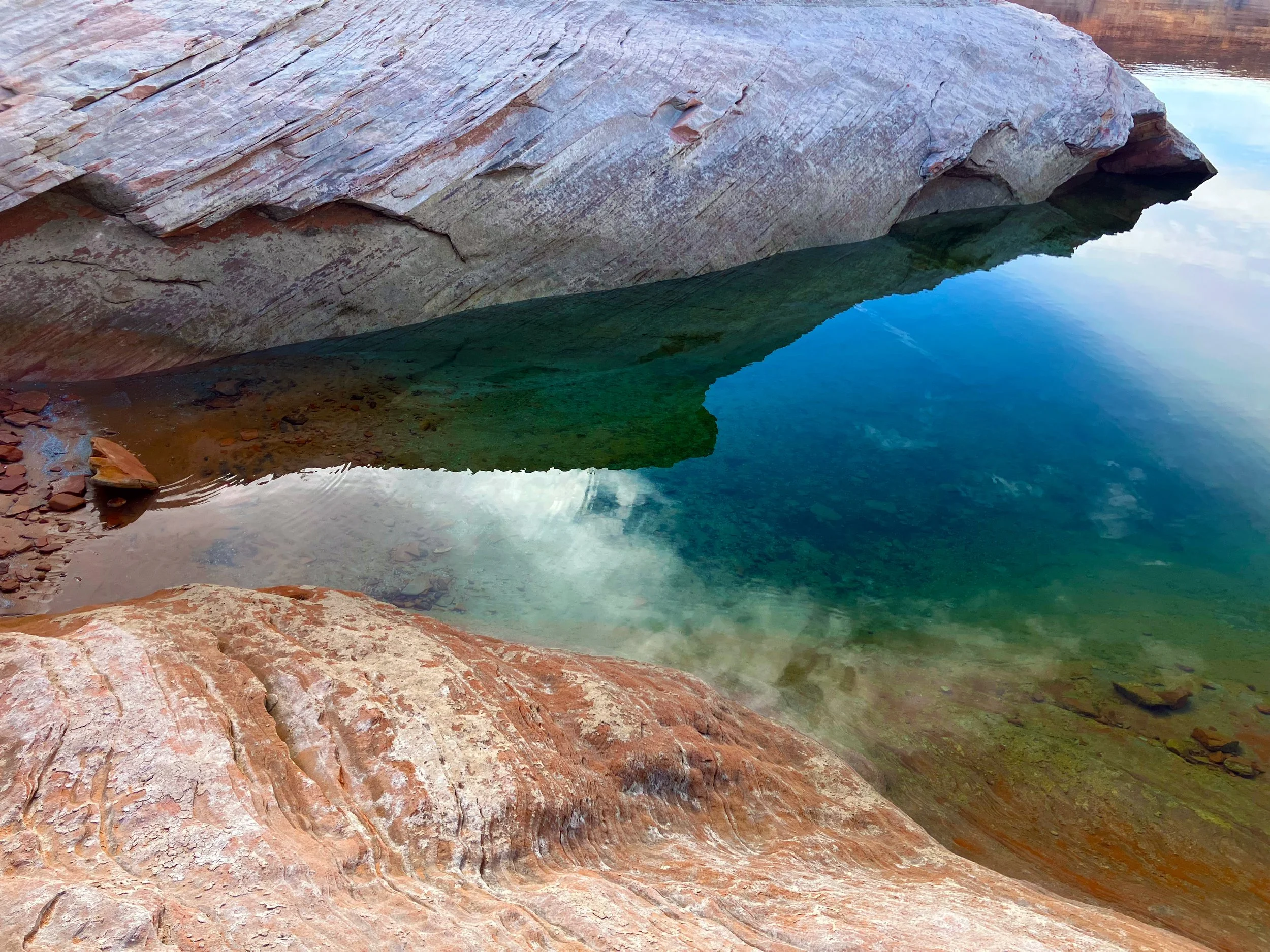 Gorgeous Blue lakeside water surface with rocks