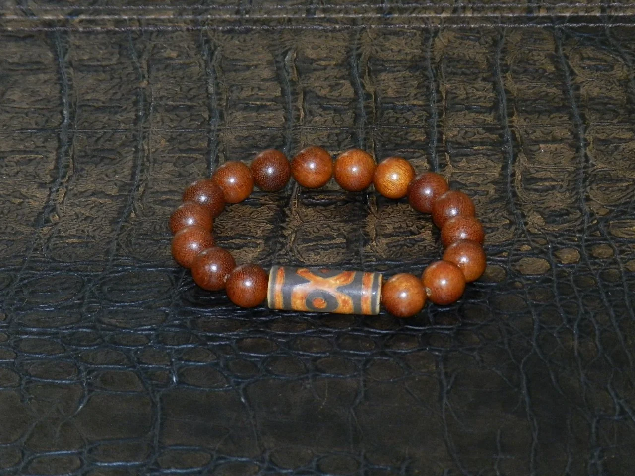 Handmade from 30mm Natural Tibetan Agate DZI, anchored by an amazing array of 12mm Sibucao Wood Beads from the Philippines.  Fits Wrists Size: 7” - 7.5”