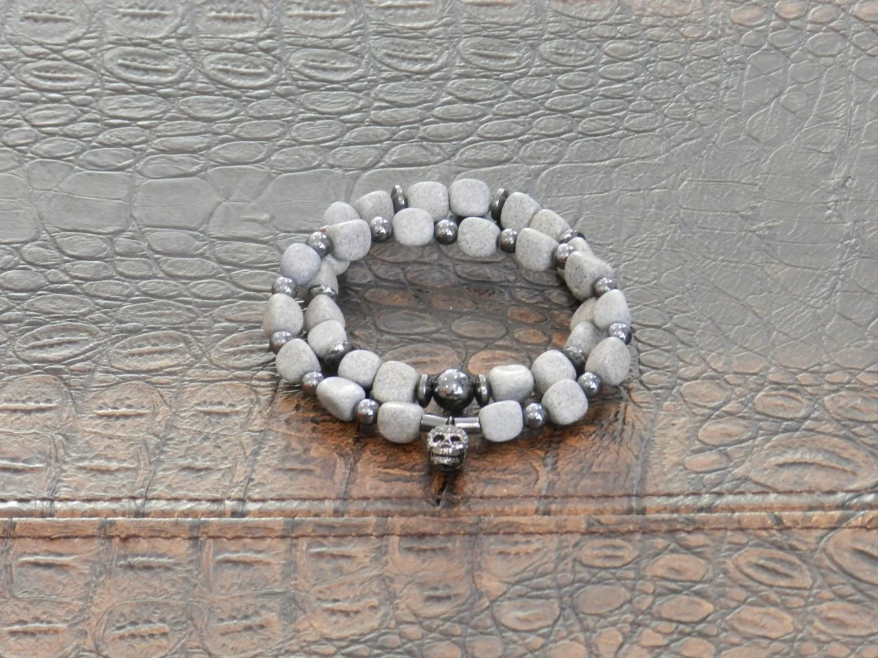 Handmade Set with Polished Natural River Rocks, Hematite Spacers, anchoring a Skull Decorated with Rhine Stones.   Fits Wrists Size: 7.5” - 8”