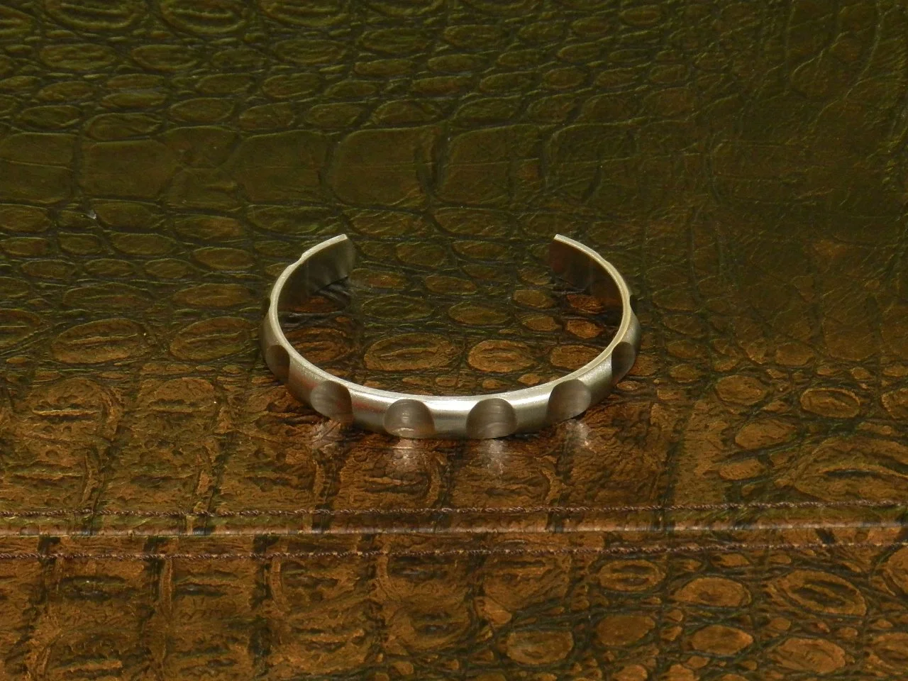 B. Tiff Simplicity Round Pattern Adjustable Gold Plated Stainless Steel Bangle Cuff. Hypoallergenic and incredibly durable. Width: 11mm, Thickness: 2.5mm, Fits Wrists Size: 7.1" - 7.5"