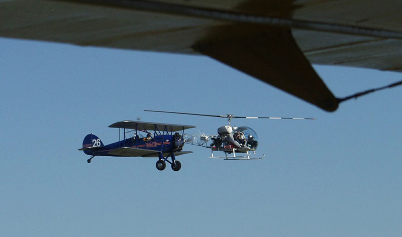 Bell 47 and biplane flying together