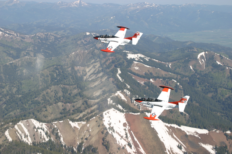 Two North American T-2 Buckeye's flying over mountains