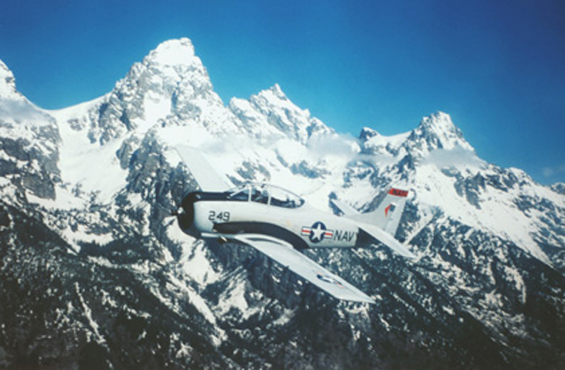 North American T-28 Trojan flying with teton mountains in background