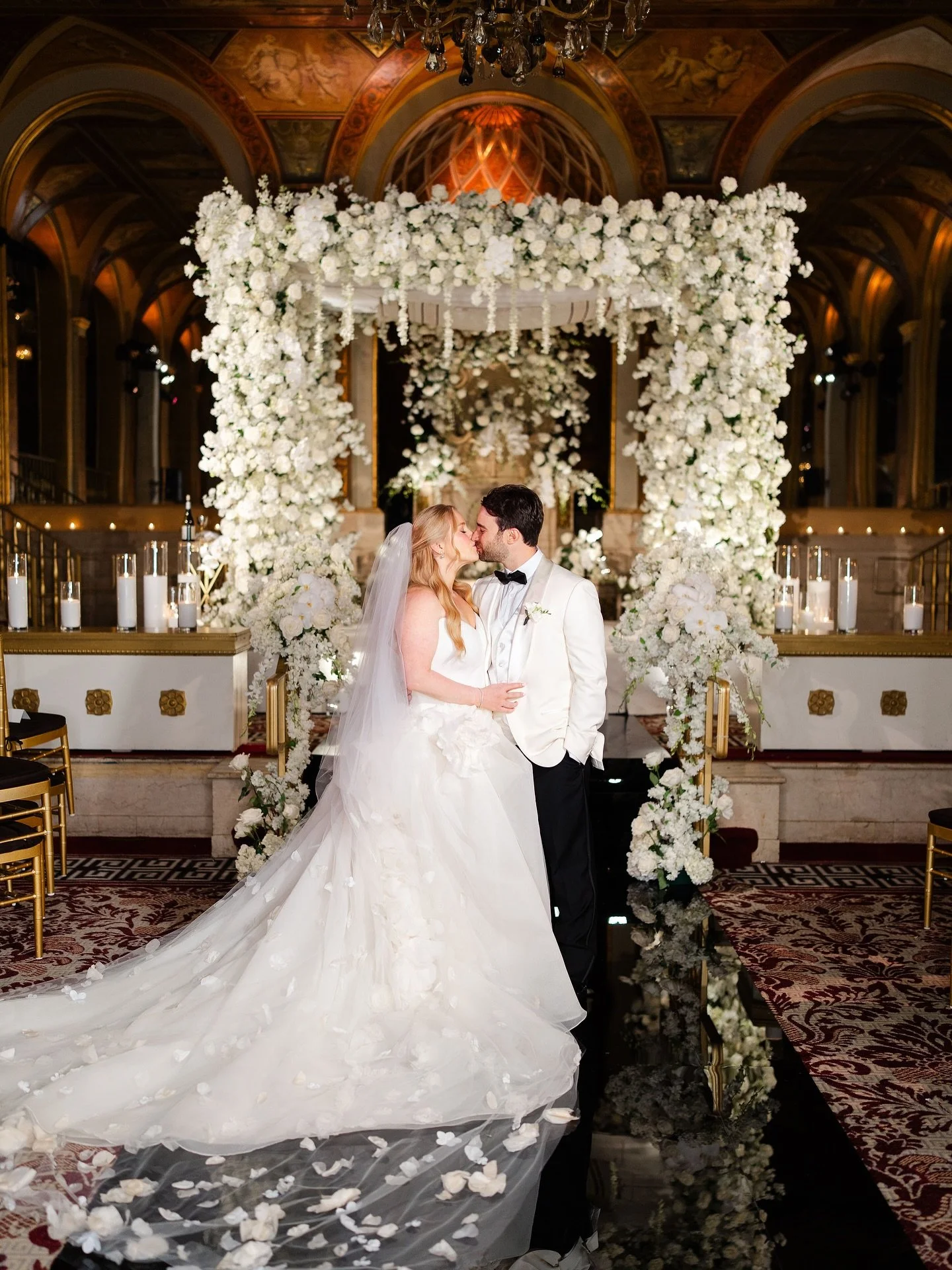 An edgy twist on a classic wedding at The Plaza Hotel. A black acrylic aisle led guests from the Palm Court to the Terrace Room for Laura and Jacob&rsquo;s wedding ceremony. We opted for an all white chuppah, a beautiful contrast to the black aisle. 