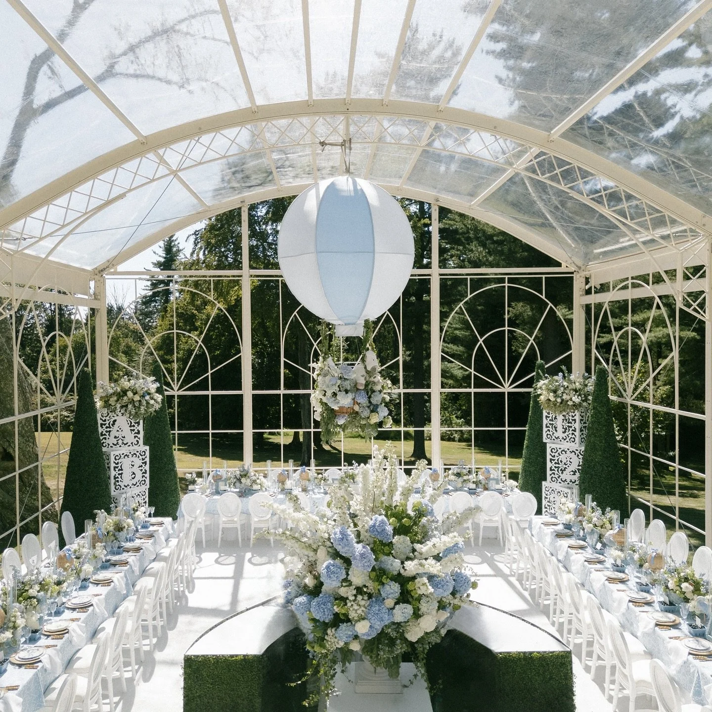 A baby blue baby shower set in the middle of a garden. Filled with whimsical touches of oversized building blocks, hot air balloons, stuffed animals, storks and more, the details for this party were truly endless. Which detail is your favorite? Event