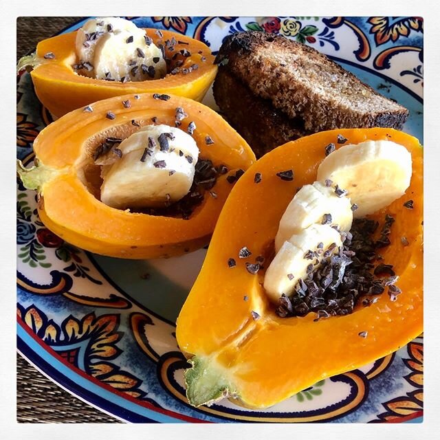 Our favorite breakfast!  Home grown papayas and bananas, local cacao nibs, artisan bread and honey 🍯 grateful for this paradise #eatlocal #homegrown #papaya #tropical #luckywelivehawaii #bigislandlove #konalaniyoga