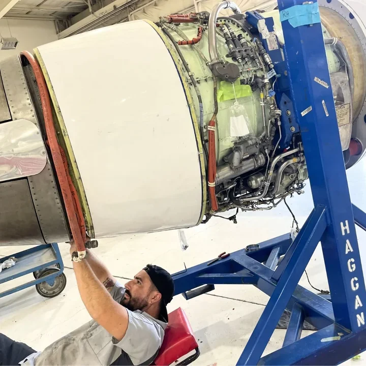 Haggan technician atop a business jet engine