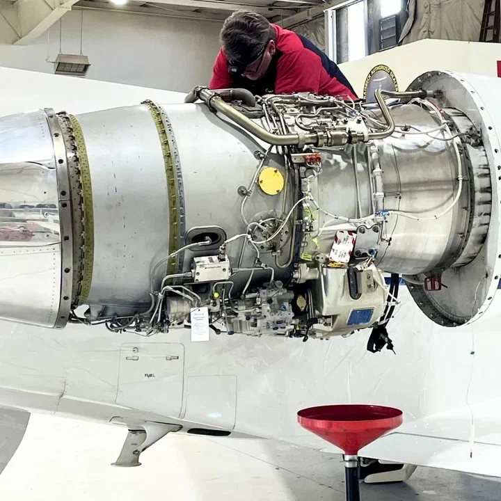 Haggan Aviation technician performing line service on a business jet engine