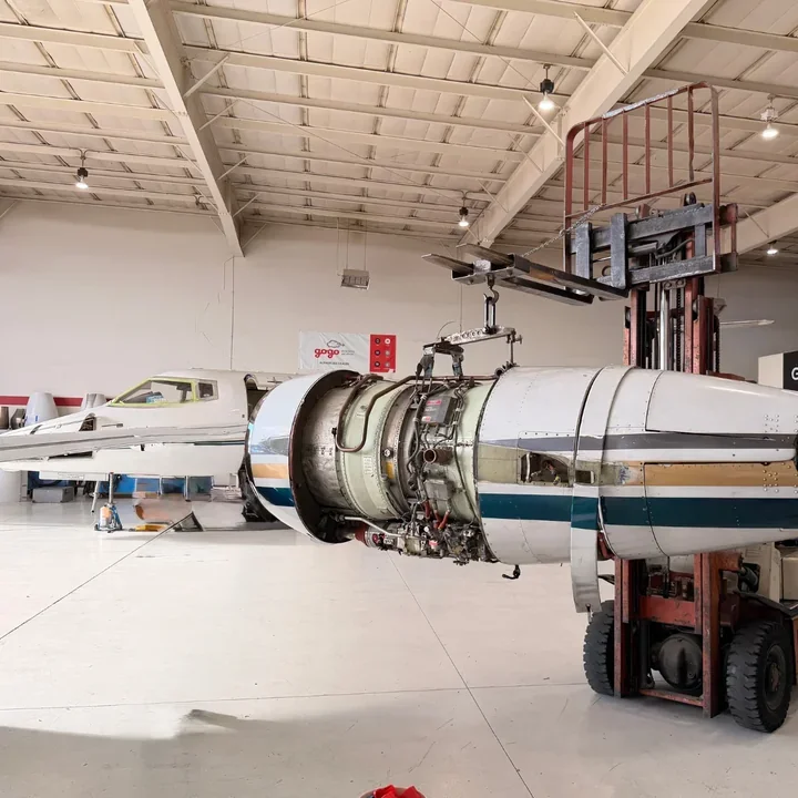 Engine removal on a Hawker 800 using a forklift and hoist