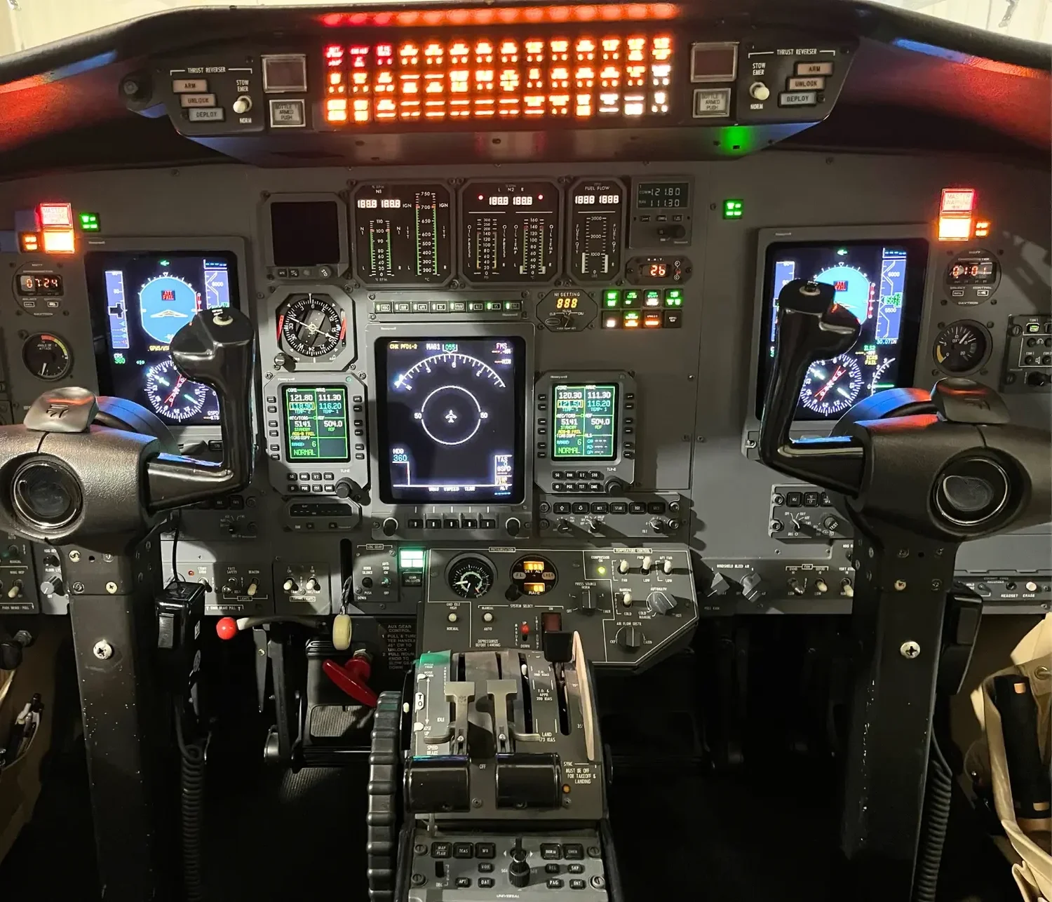 Business jet flight deck with illuminated annunciator panel at Haggan Aviation