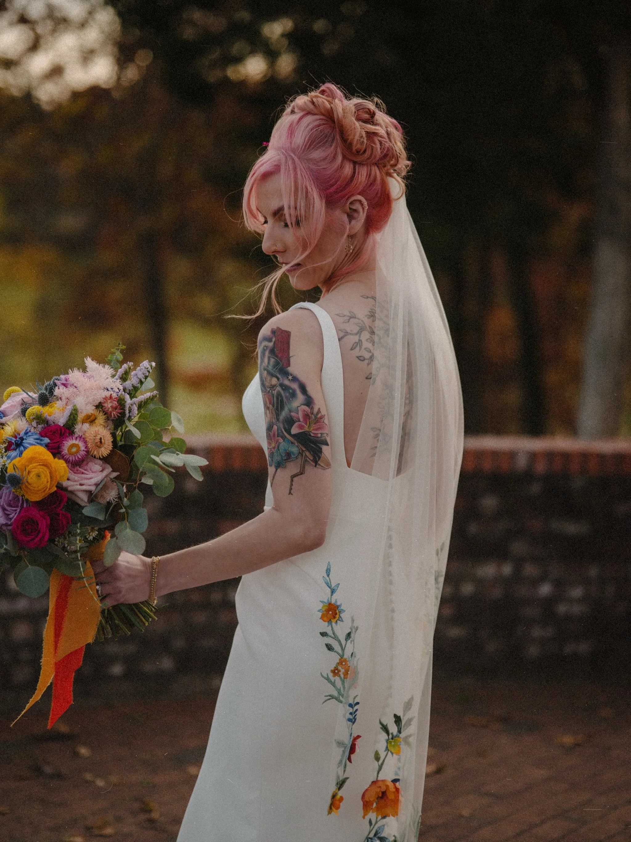 For the brides who make their own rules.
completely obsessed with everything about this look-the pink hair, the stunning tattoos, and that incredible embroidered veil. Non-traditional, effortlessly intentional, and 100% unique.
#BrooklynBride
#Brookl