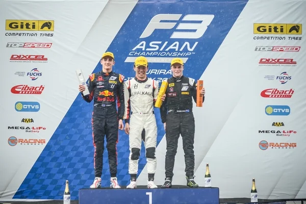 Ukyo Sasahara on the top step of the Race 6 podium.