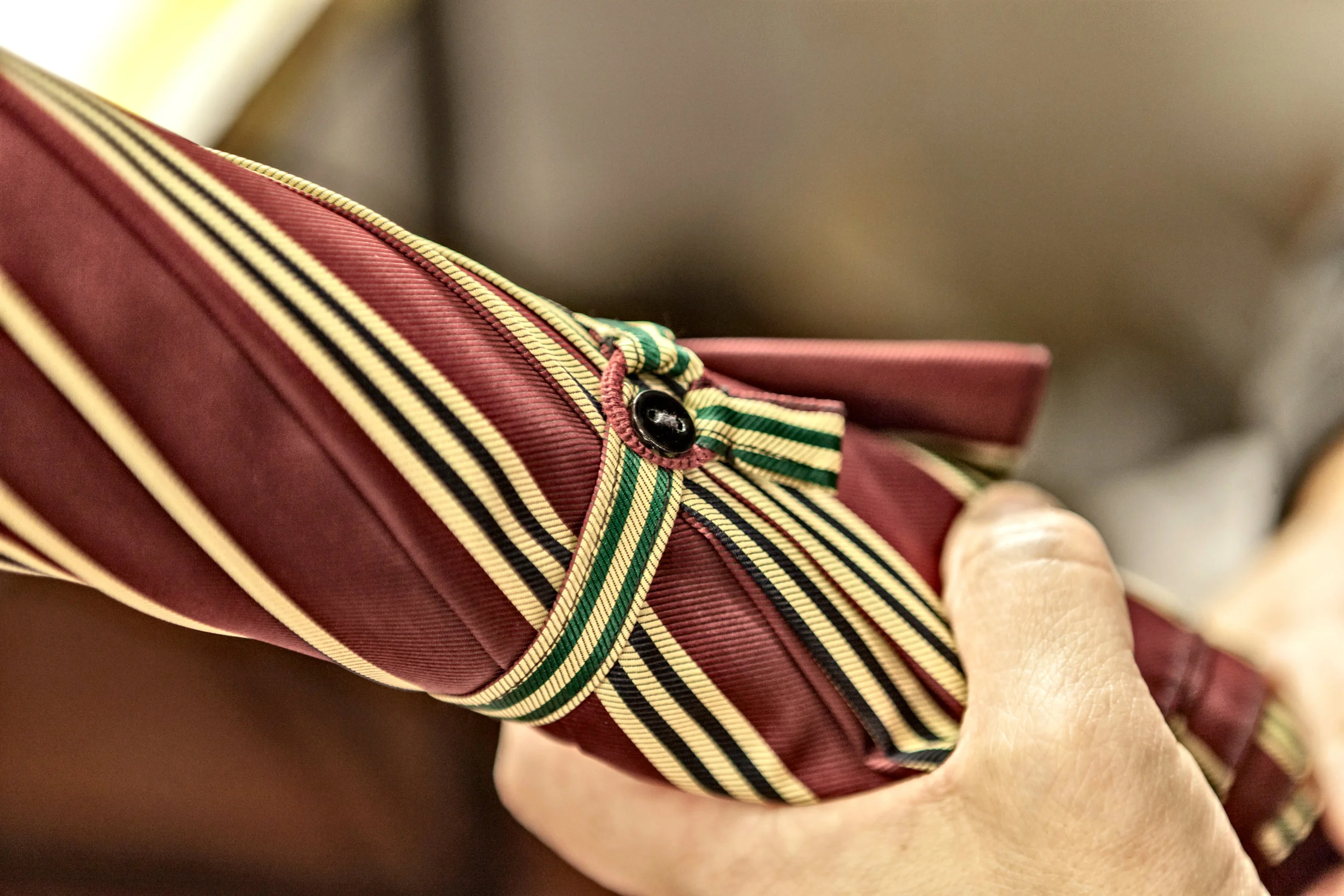 Detail of an hand-sewn umbrella’s closing band. Photo credit: LucaPradella